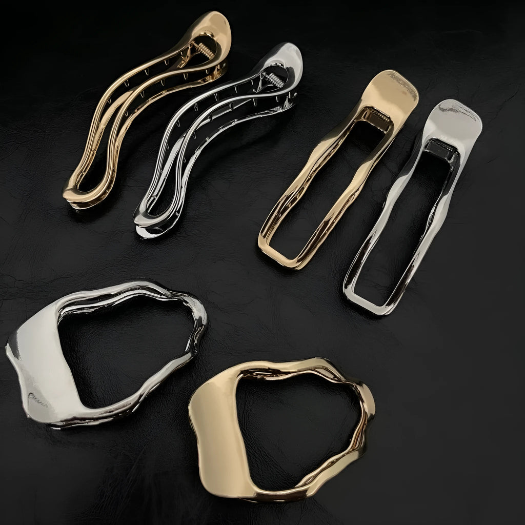 Gold and silver zinc alloy hair barrettes in arc, square, and triangle shapes.