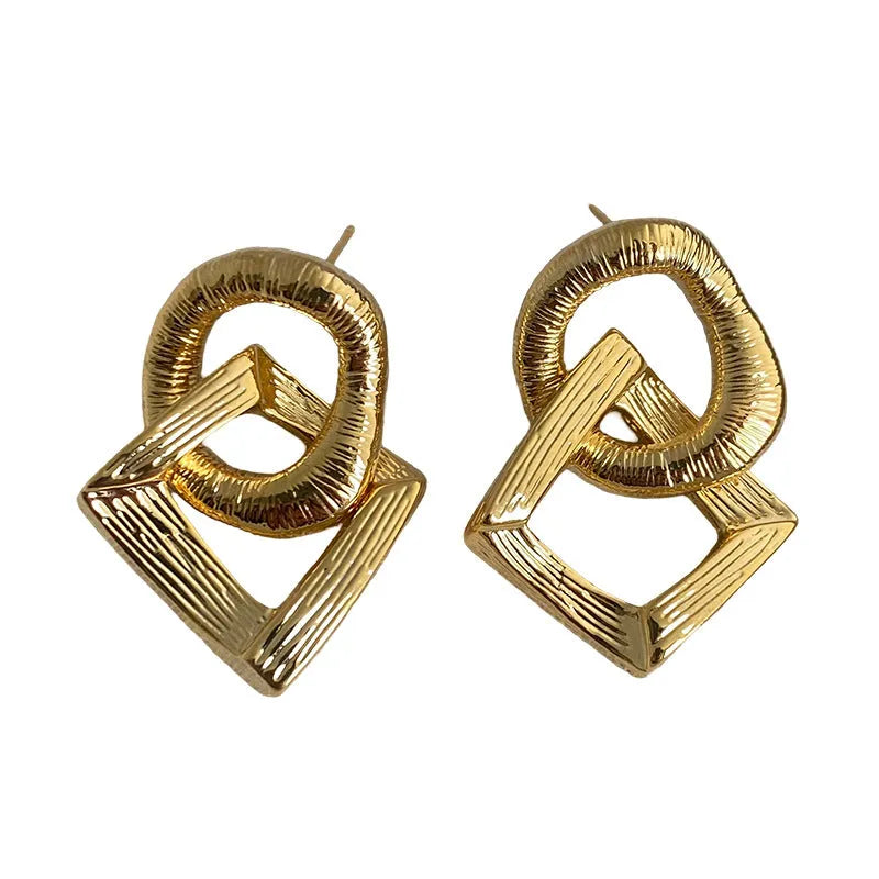 Geometric circle pendant drop earrings in gold or silver tone with a 3.4cm length.