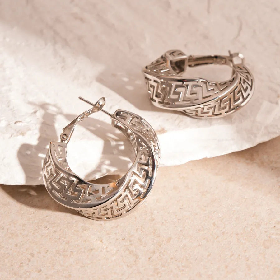 Geometric women's earrings with twisted round hollow stud design in silver or gold finish