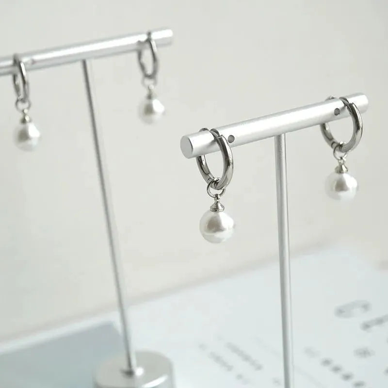 Geometric alloy drop earrings for women with round titanium steel pearl accents.