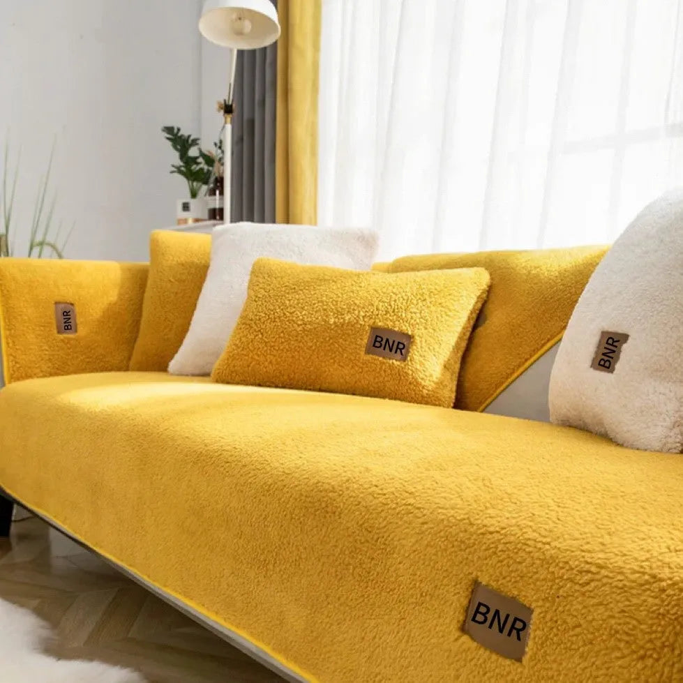 Lambswool sofa slipcover in solid blue colour on a grey sofa