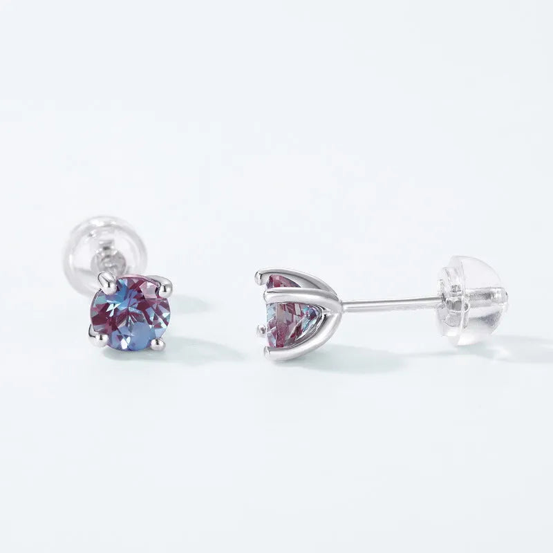 A pair of round, geometric 925 silver ear studs featuring a cultivated Alexandrite Alexander Stone.