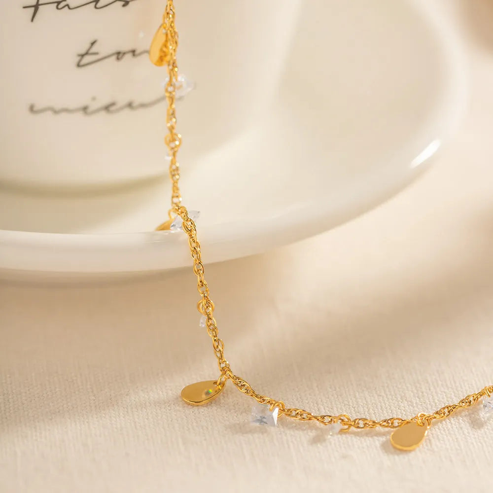Women's stainless steel anklet with geometric water drop tassel design in silver.