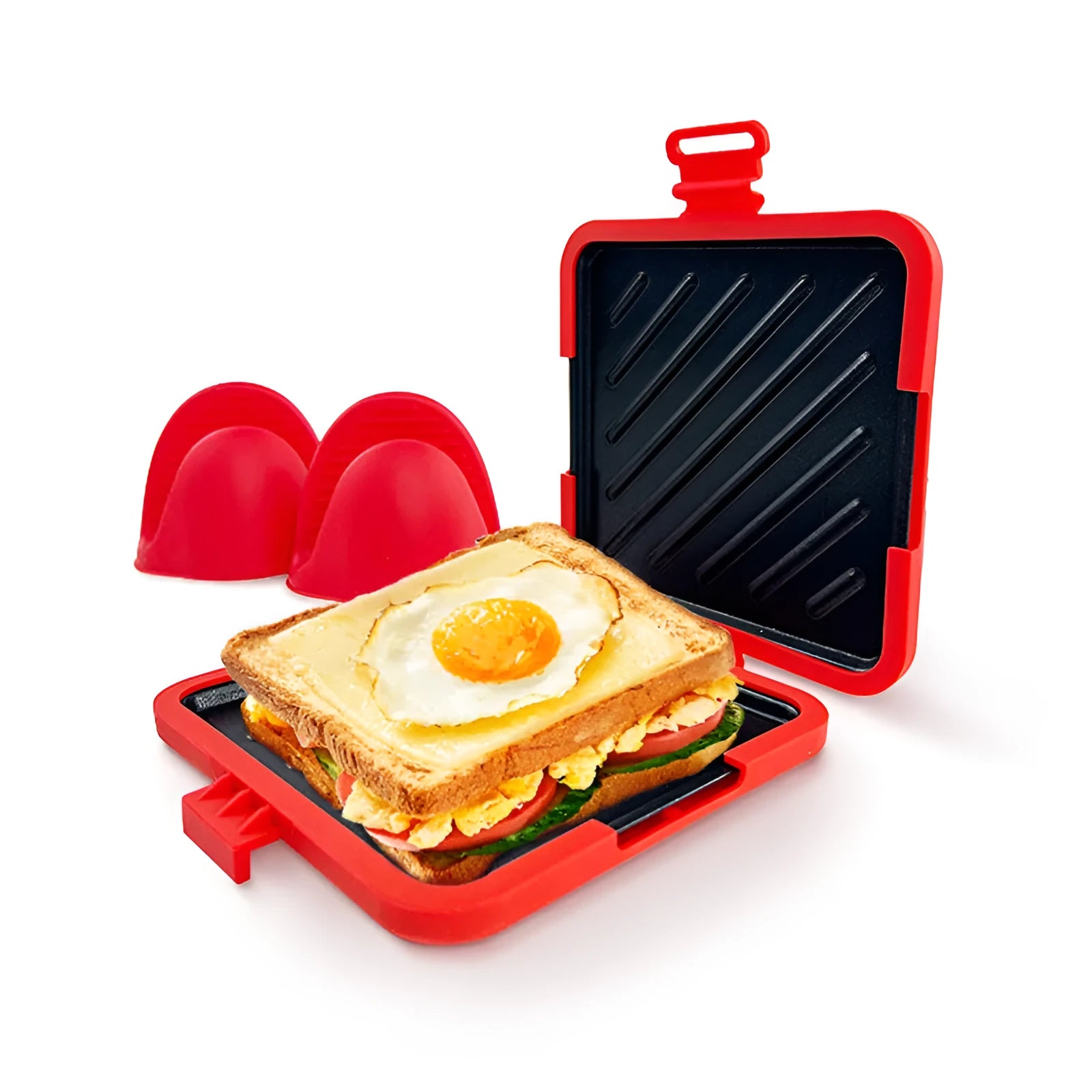Red silicone baking tray with integrated handle and a pair of matching silicone oven gloves on a kitchen counter.