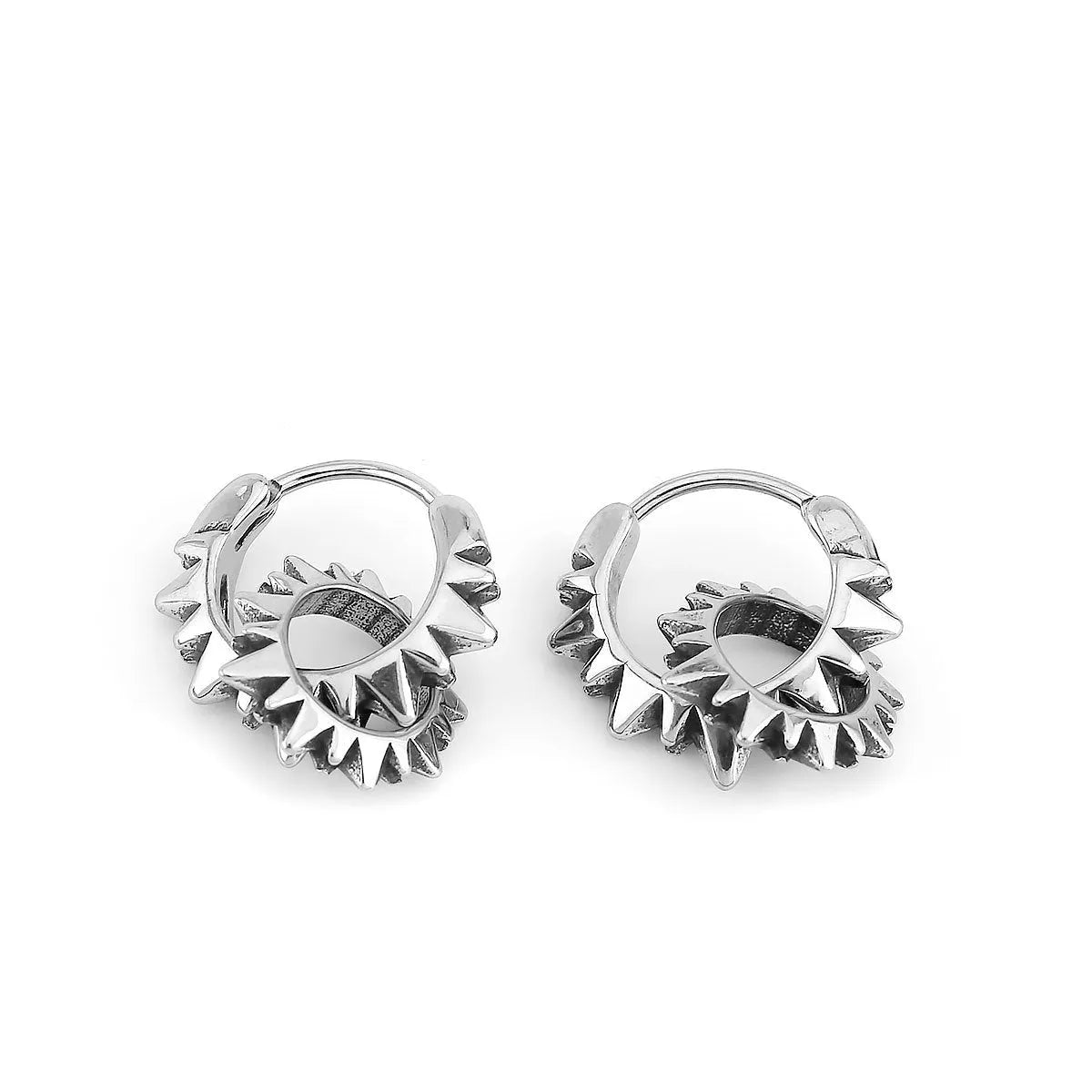 A pair of polished stainless steel round ring earrings in a steel colour on a plain background.