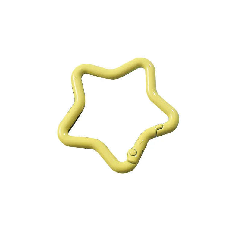 Zinc alloy five-pointed star keychain in light pink colour on a white background.