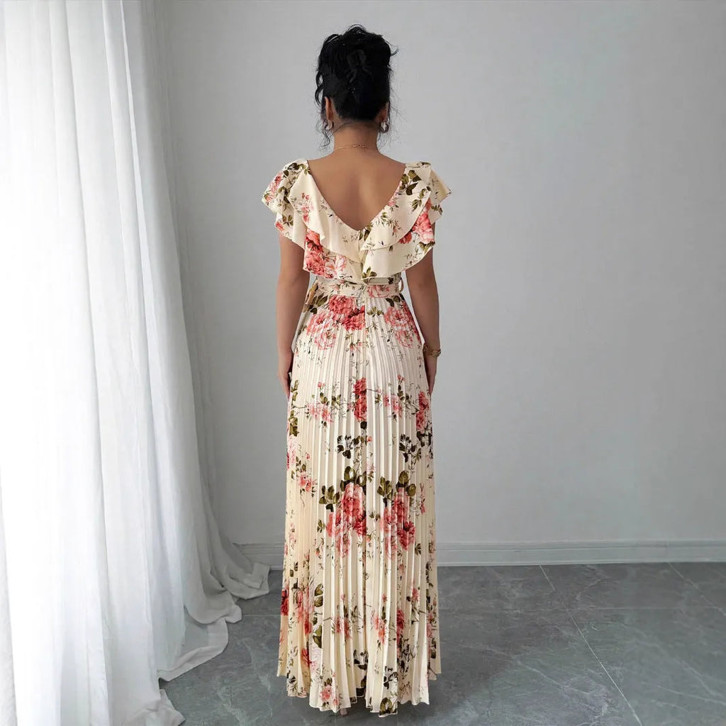 Apricot floral print v-neck dress with ruffled sleeves and a long, pleated swing skirt.