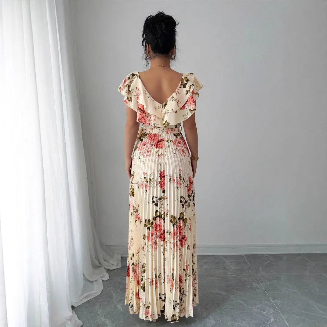 Apricot floral print v-neck dress with ruffled sleeves and a long, pleated swing skirt.