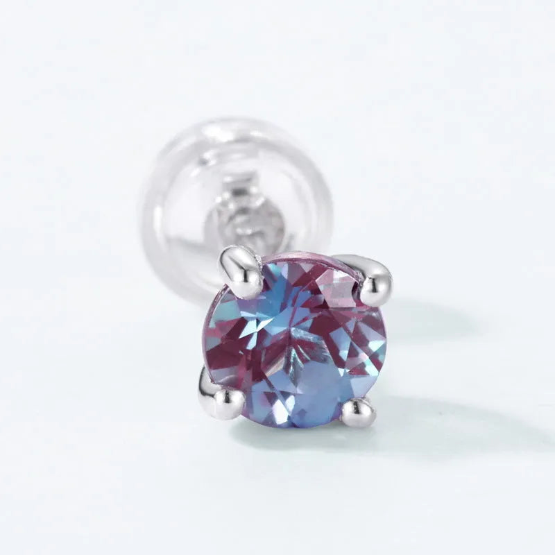 A pair of round, geometric 925 silver ear studs featuring a cultivated Alexandrite Alexander Stone.