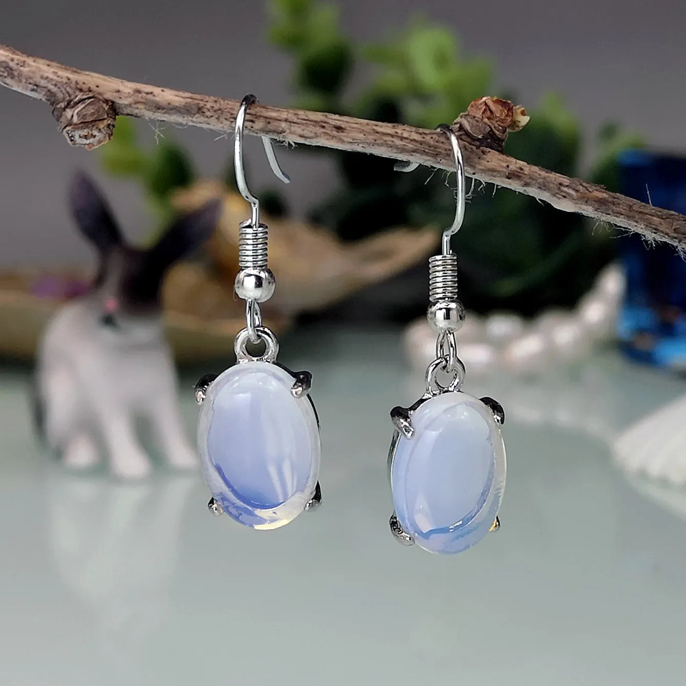 Moonlight white opal earrings with a retro cross pendant in a drop shape