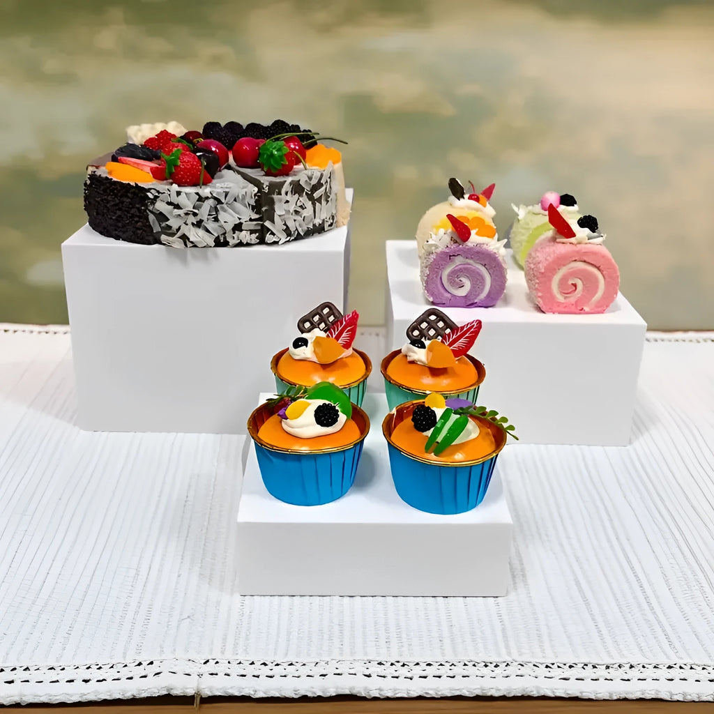 White plastic modular dessert display stand with six interlocking cubes for cake and pastry presentation