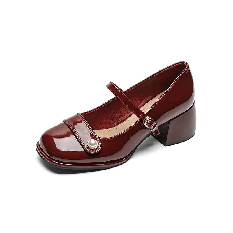 Women's apricot patent leather heel pumps with a chunky block heel and buckle fastening