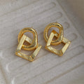Geometric circle pendant drop earrings in gold or silver tone with a 3.4cm length.