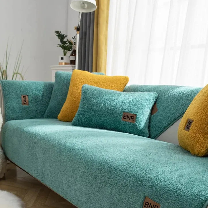 Lambswool sofa slipcover in solid blue colour on a grey sofa