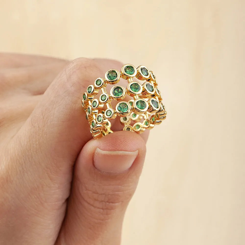 Gold plated copper ring with three green zircon stones in layered arrangement on wide band