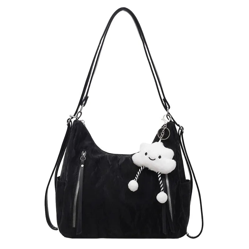 Soft black PU leather women's backpack shown with detachable pendant accessory.