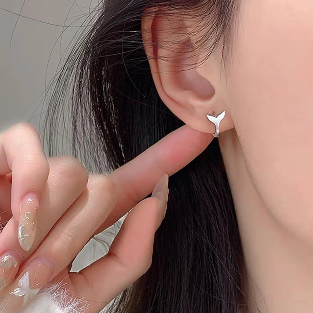 Women's fashion fishtail earrings in copper with electroplated white gold and yellow gold finishes