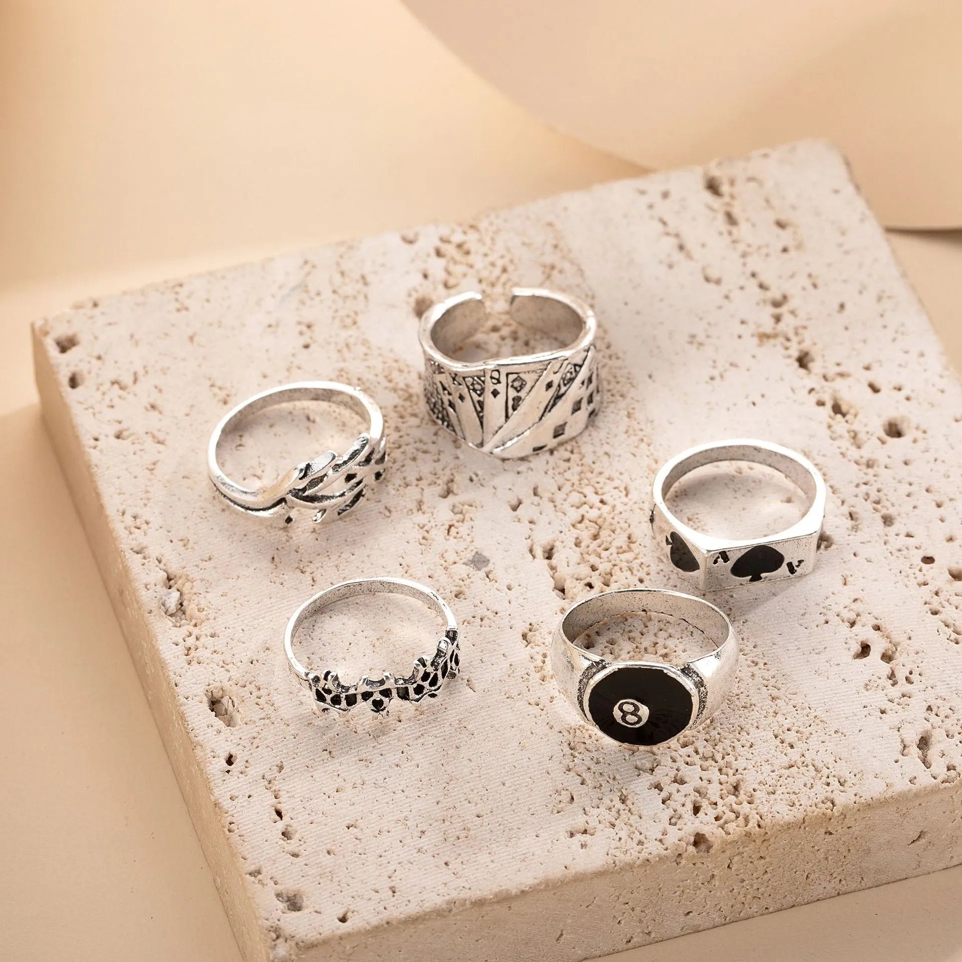 Black alloy poker ring with a detailed retro spade design on a female model's hand.
