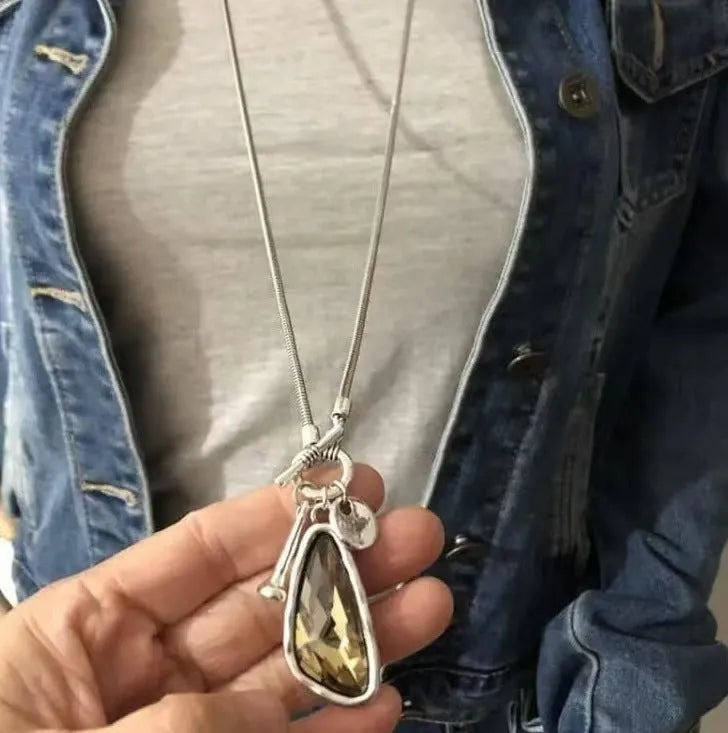Women's long necklace with geometric pendant on snake bones chain in blue water drop finish