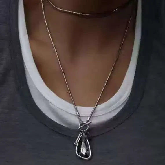 Women's long necklace with geometric pendant on snake bones chain in blue water drop finish
