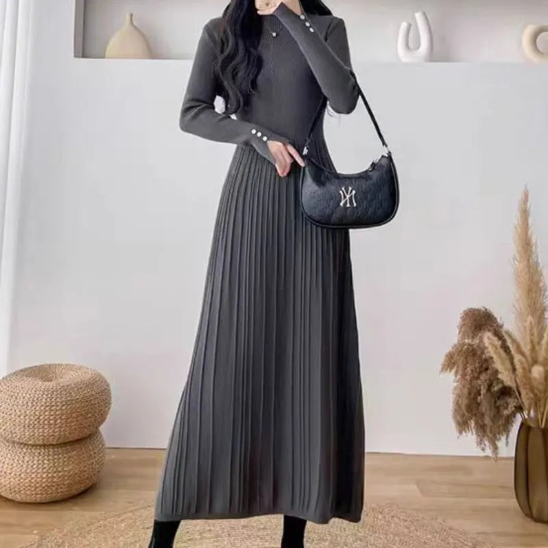 Women's high-waist knitted A-line skirt dress in a solid colour, mid-length below the knees.