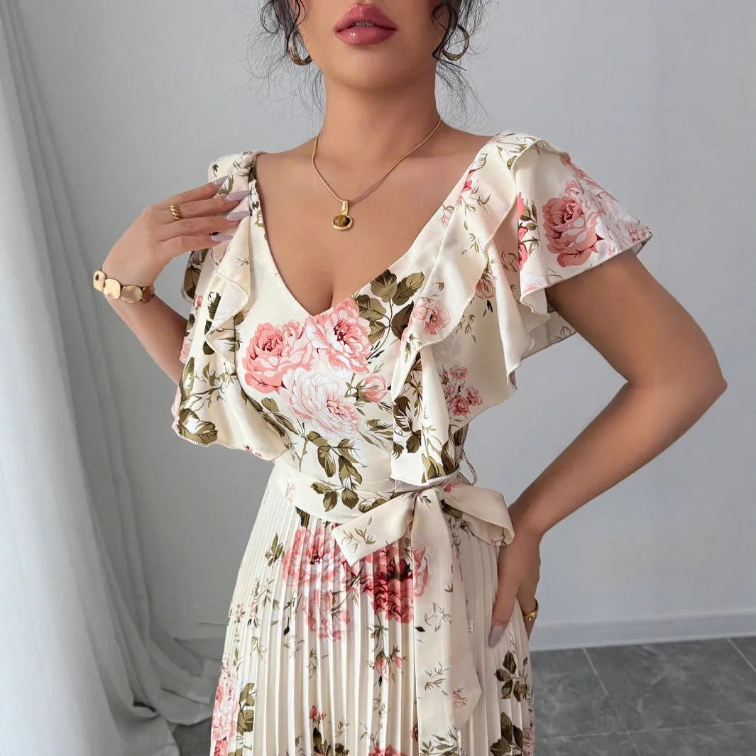 Apricot floral print v-neck dress with ruffled sleeves and a long, pleated swing skirt.
