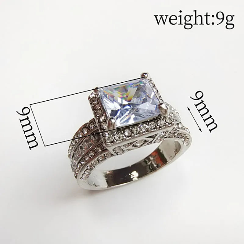 Geometric women's alloy ring with round details in gold or white electroplated finish.
