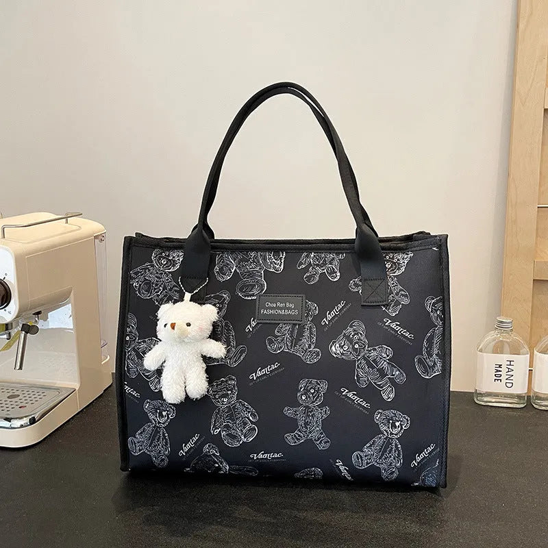 Women's soft canvas tote bag in black, showing large capacity, sandwich pockets, and a rhombus pattern detail.