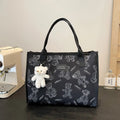Women's soft canvas tote bag in black, showing large capacity, sandwich pockets, and a rhombus pattern detail.
