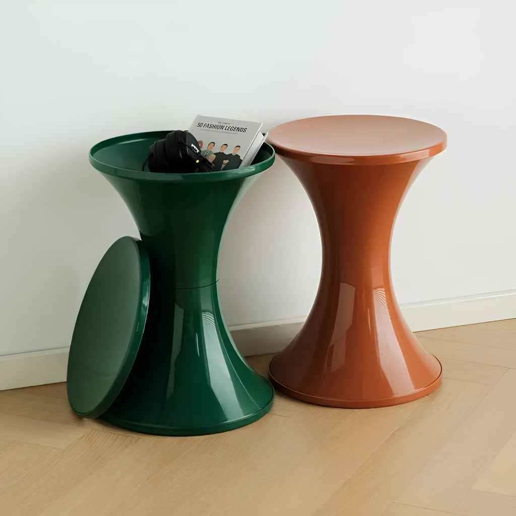 A plastic hourglass-shaped shoe changing stool in green colour on a wooden floor.
