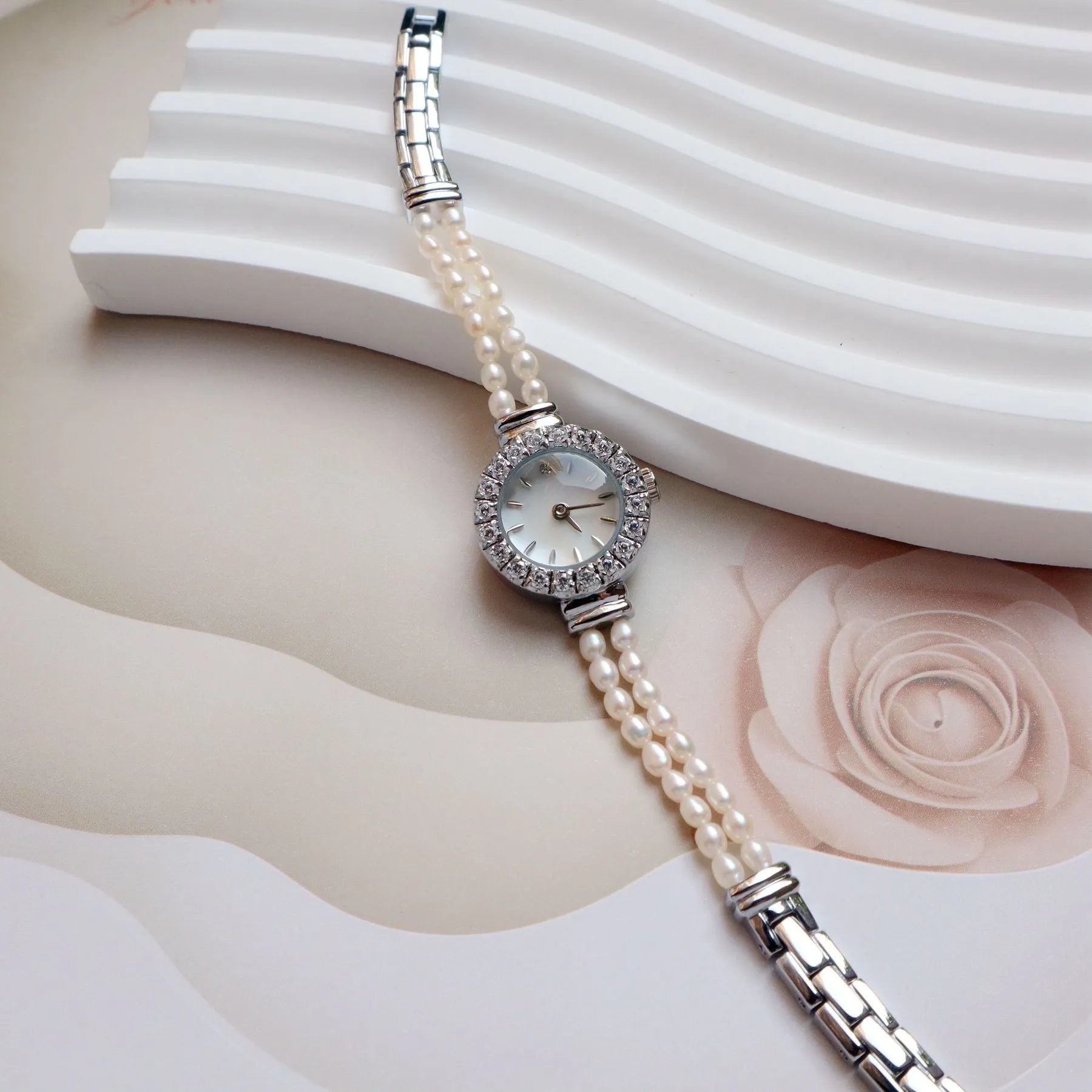 Light gold women's bracelet watch with freshwater pearls and 18mm round dial