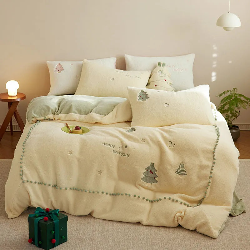 Princess-style four-piece bedding set with green Christmas tree pattern on a bed.