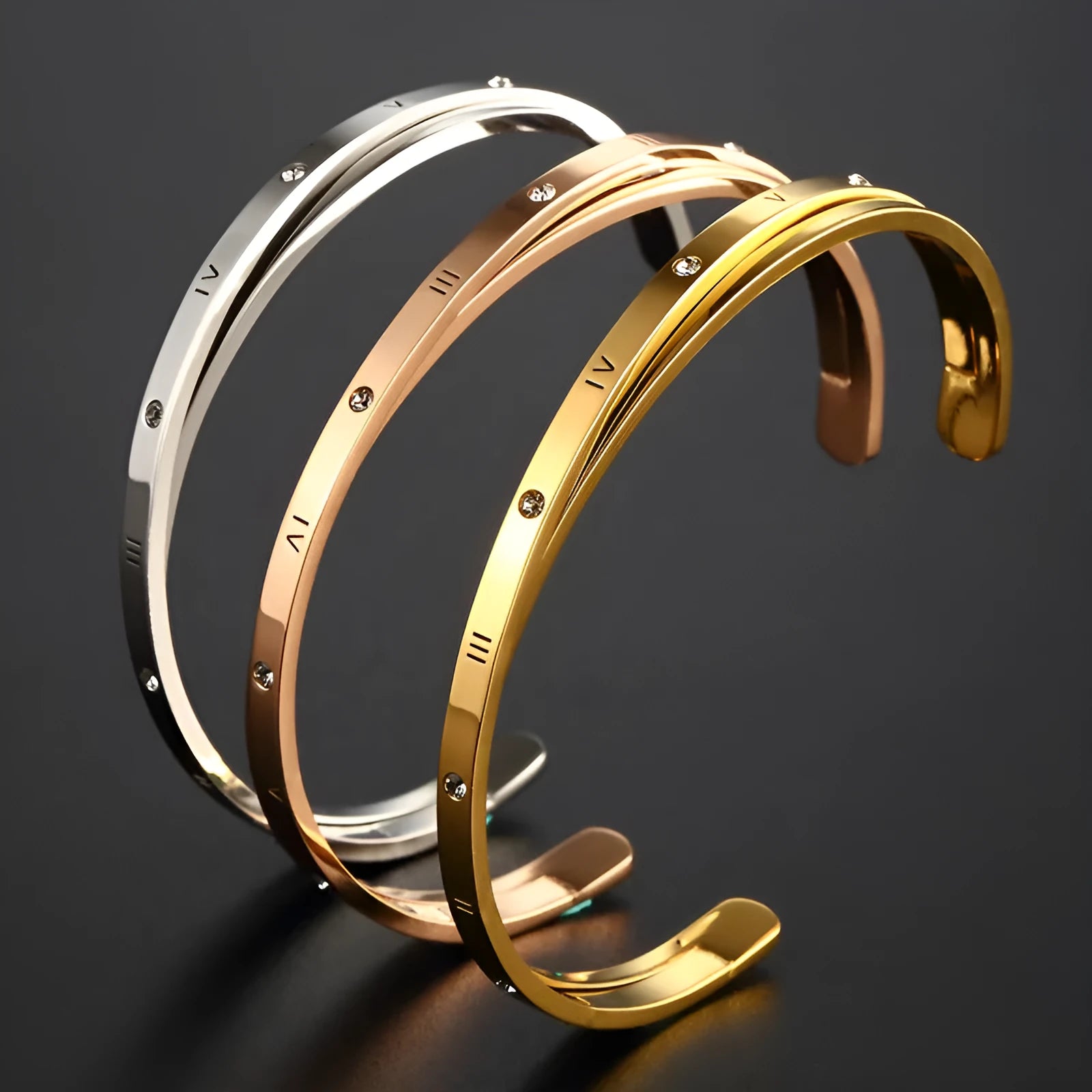 Open-ended stainless steel bracelet with zircon stones and love motif in electroplated gold finish