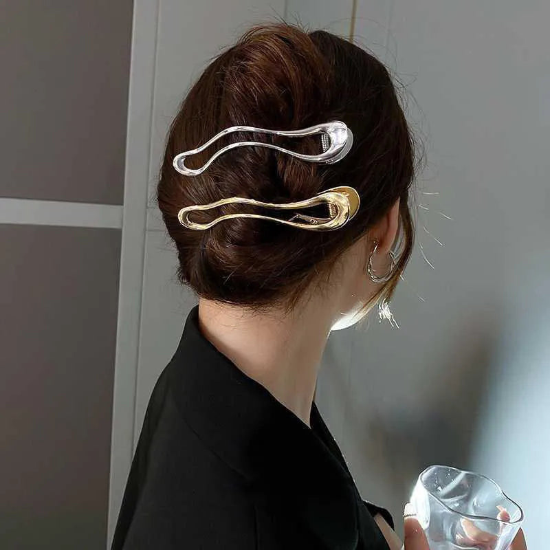 Gold and silver zinc alloy hair barrettes in arc, square, and triangle shapes.