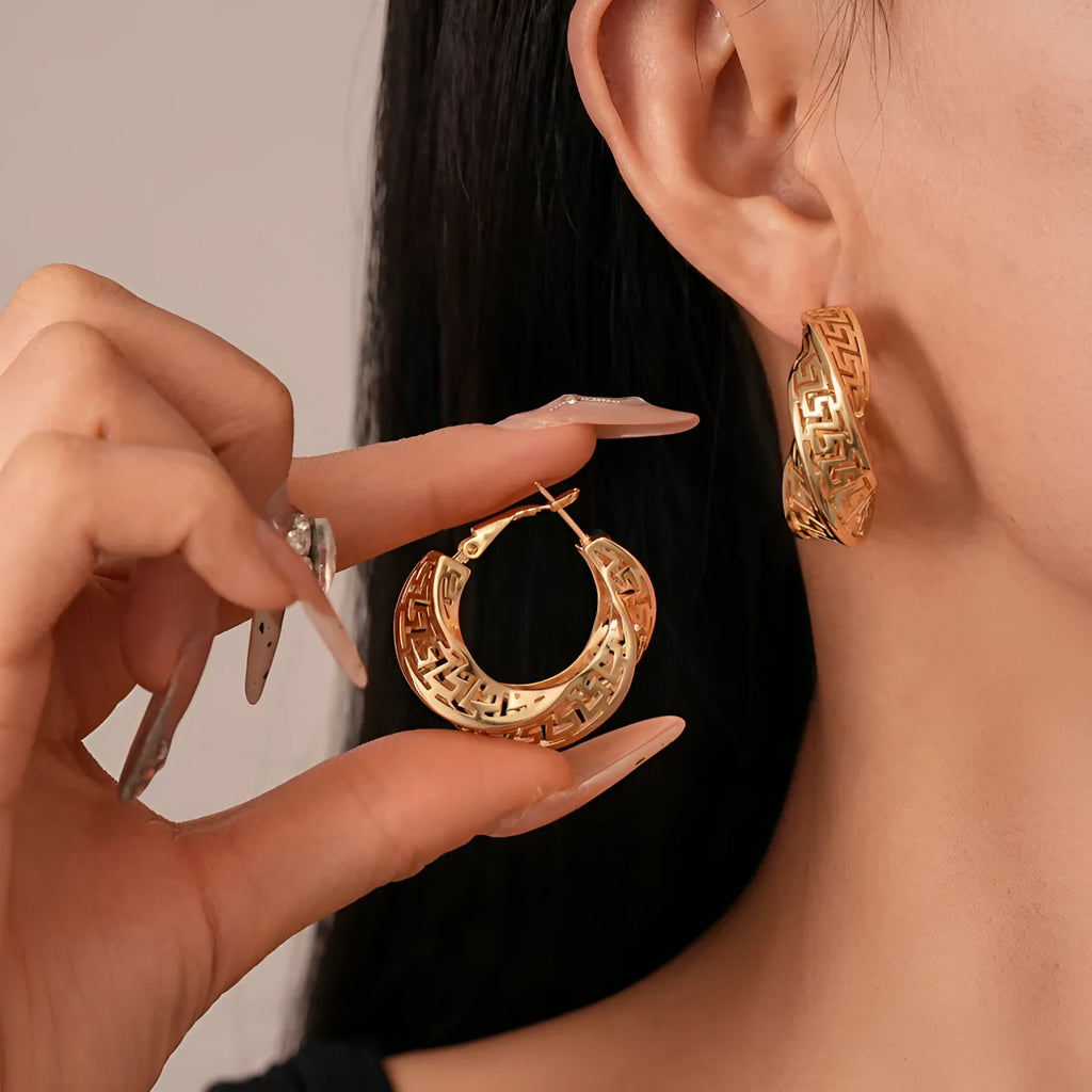 Geometric women's earrings with twisted round hollow stud design in silver or gold finish