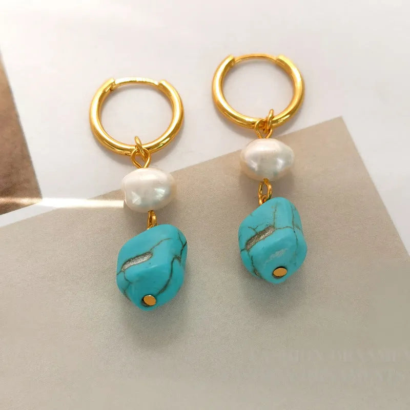 Geometric turquoise and cultured pearl earrings in short stud and long dangle styles on copper settings.