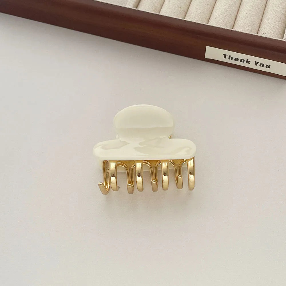 Medium metal grip acetate hair barrettes in four colours: fairy white, leopard print, creamy-white, and ink colour