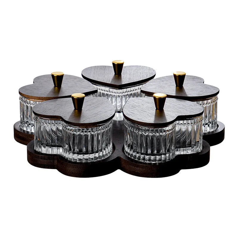 Glass fruit platter with transparent heart-shaped lids covering compartmentalised snack trays in retro design