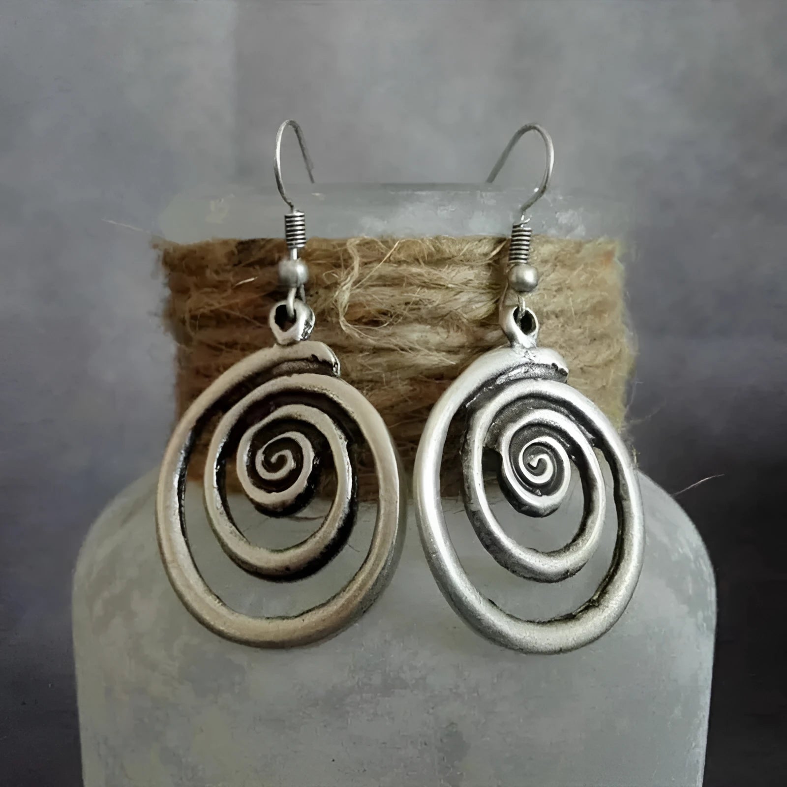 Silver geometric spiral distressed alloy dangle earrings showing retro design.