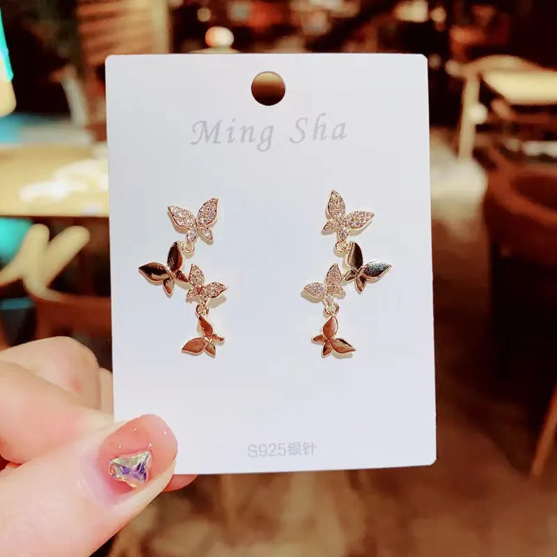 Women's butterfly copper drop earrings with gold finish for pierced ears