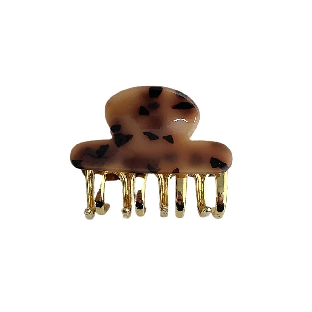 Medium metal grip acetate hair barrettes in four colours: fairy white, leopard print, creamy-white, and ink colour