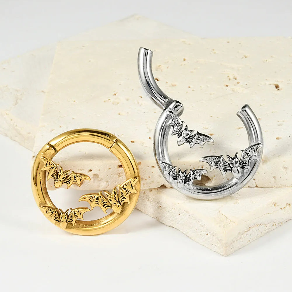 A pair of silver totem pattern stainless steel fashion earrings on a white background.
