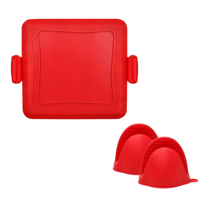 Red silicone baking tray with integrated handle and a pair of matching silicone oven gloves on a kitchen counter.