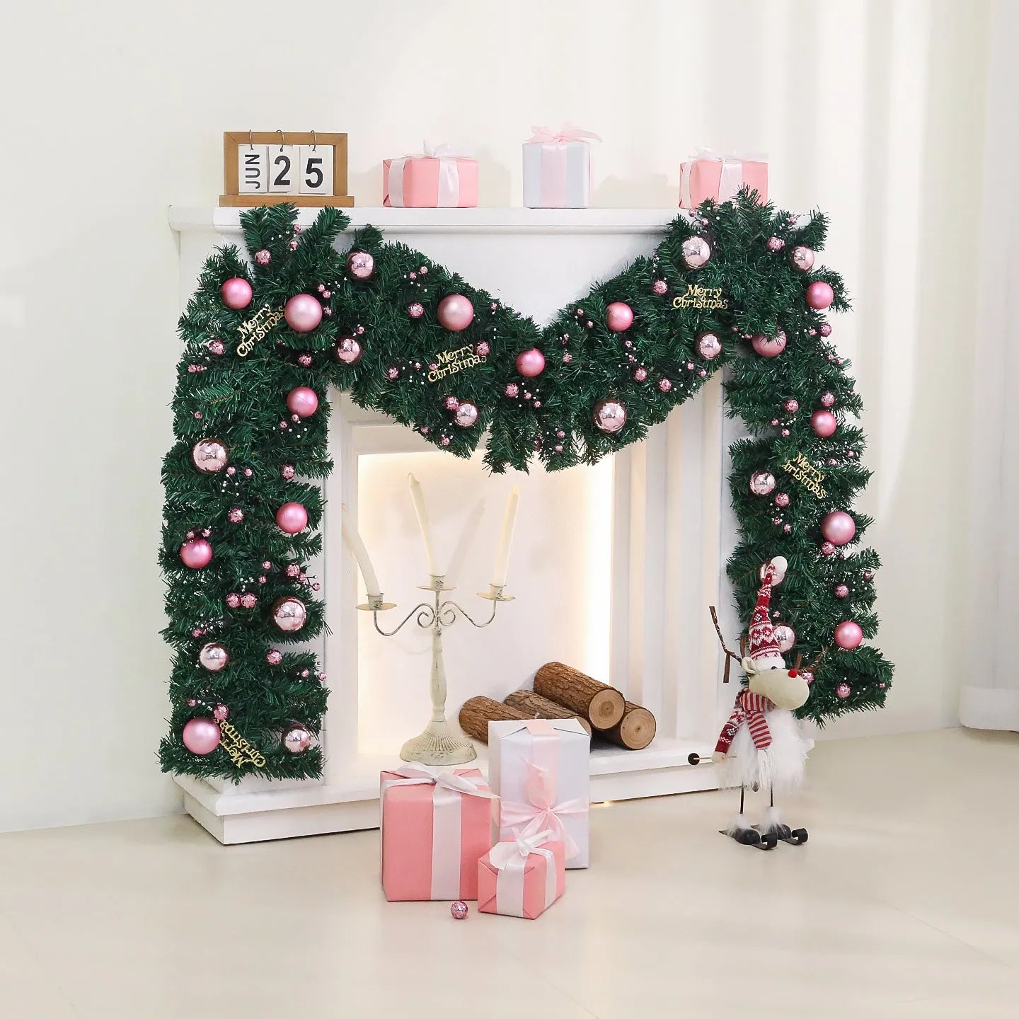 Pink Christmas rattan garland with small fruit details and LED lights draped across doorway