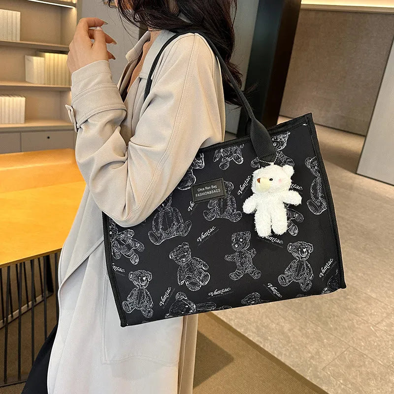 Women's soft canvas tote bag in black, showing large capacity, sandwich pockets, and a rhombus pattern detail.