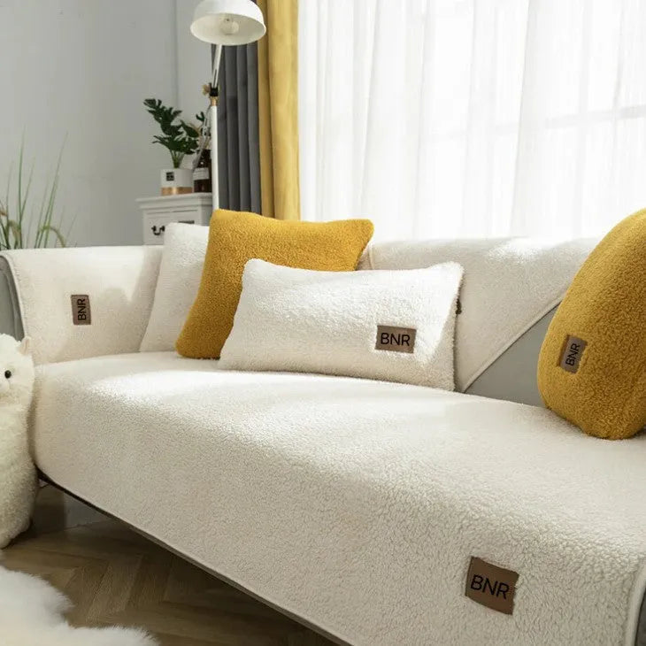 Lambswool sofa slipcover in solid blue colour on a grey sofa