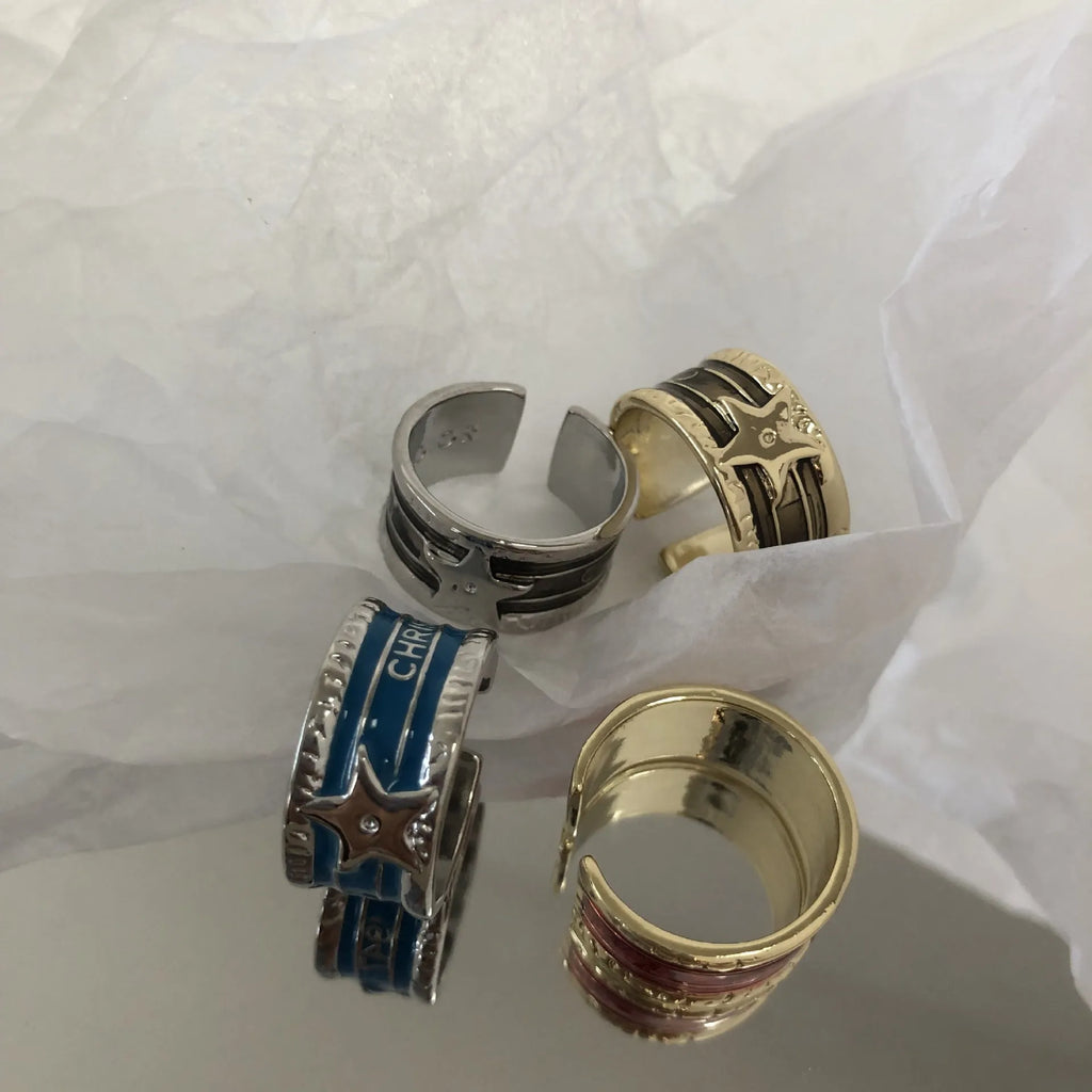 Adjustable geometric drop oil copper ring with a distressed finish in multiple colours.