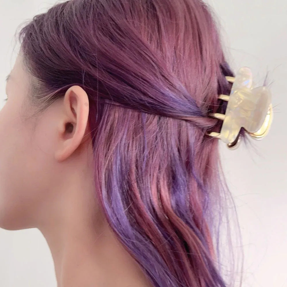 Medium metal grip acetate hair barrettes in four colours: fairy white, leopard print, creamy-white, and ink colour