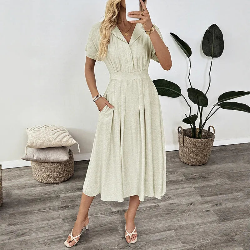 Light green women's shirt dress with lapel collar, waist-tight skirt, and pockets