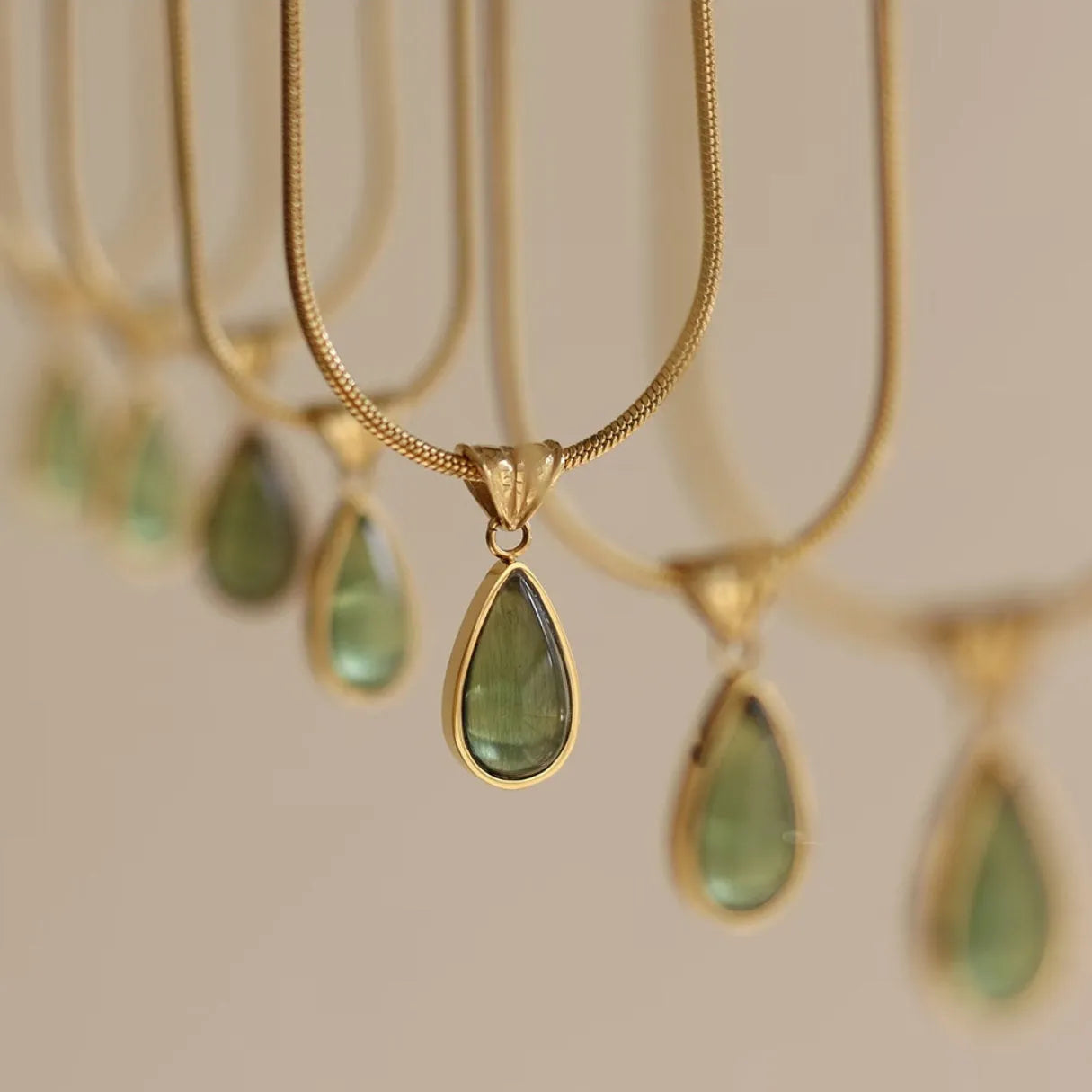 Water drop pendant necklace with gemstone inlay on snake bone chain in blue or green colour